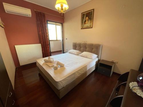 a bedroom with a large bed in a room at Grand Luxury Apartment Seafront Kalamata in Kalamata