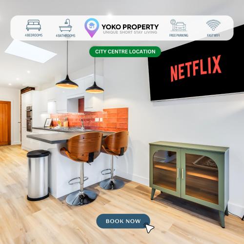 a kitchen with a counter and stools in a room at 4 Bedroom 4 Bathroom House - Sleeps 7 - Prime Location, Free Parking, Self-Check-In, Workspace, Fast Wifi and Smart TV with Virgin TV and Netflix by Yoko Property in Northampton