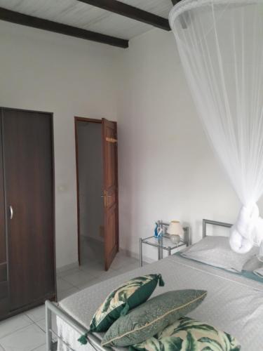 a bedroom with a bed with two pillows on it at LE VERDOYANT in Sainte-Anne