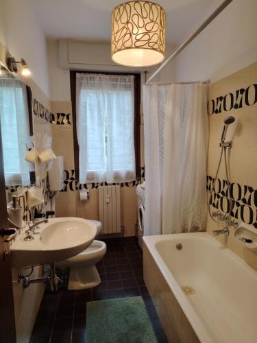 a bathroom with a sink and a tub and a toilet at La casa di Camilla in Perledo