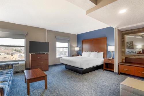 a hotel room with a bed and a tv at Comfort Suites near Birkdale Village- Huntersville in Huntersville