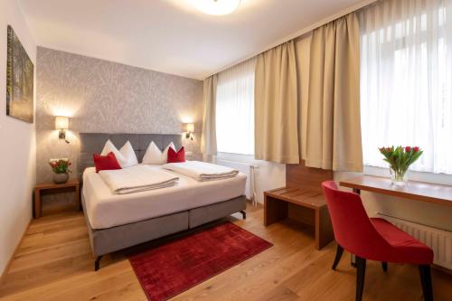 a hotel room with a bed and a desk at Hotel Mader in Steyr