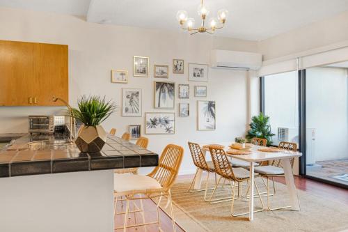 a kitchen and dining room with a table and chairs at Stunning Resort! Steps to Pool, Hot Tub and Parking in Honolulu