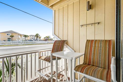 a balcony with two chairs and a table at Sandpiper Cove 8107 in Destin
