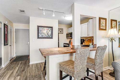 a kitchen and living room with a table and chairs at Sandpiper Cove 8107 in Destin