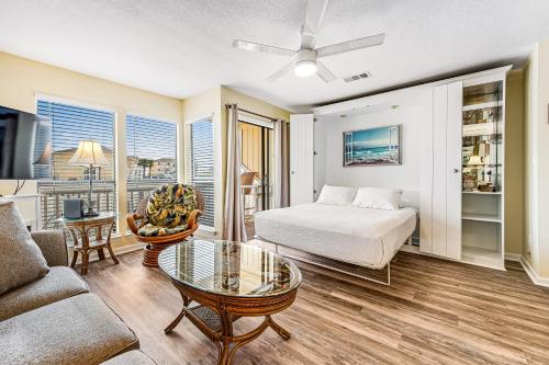 a living room with a bed and a couch at Sandpiper Cove 8107 in Destin