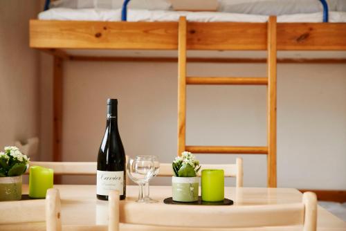 a bottle of wine sitting on a table with a glass at Danhostel Sønderborg Vollerup in Sønderborg