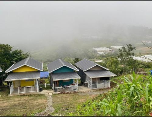a group of houses on top of a hill at Dtwinnie homestay lalita house in Kundasang
