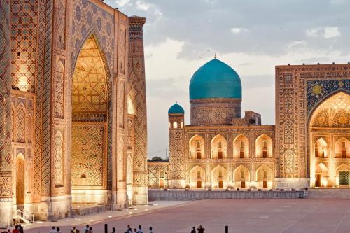 a mosque with a blue dome and people in front of it at Madaniyat 1 in Samarkand
