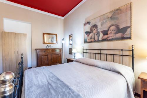 a bedroom with a bed and a painting on the wall at Corso 151 in Olbia