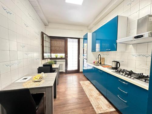 a kitchen with blue cabinets and a counter top at Grande Bellezza Luxury Suite in Mestre