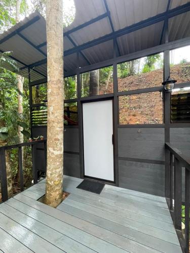 a white door in a building with a pole at Jungle Loft in Platanillo