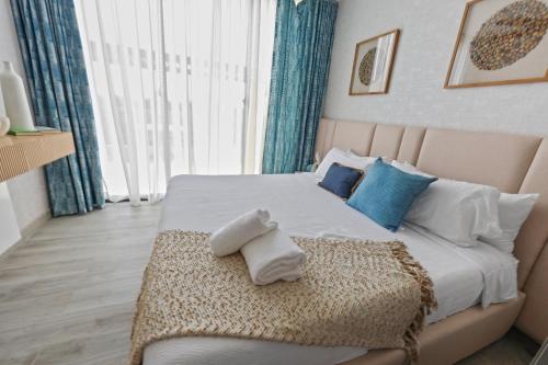 a bedroom with a bed with towels on it at 504 New, Fantastic Rooftop with Private Jacuzzi in La Laguna