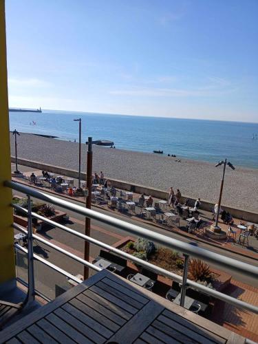 a view of the beach from a balcony of a beach at Face à la mer by Corinne in Mers-les-Bains