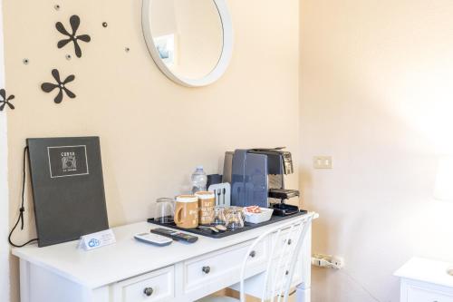 a room with a table with a microwave and a mirror at Corso 151 in Olbia