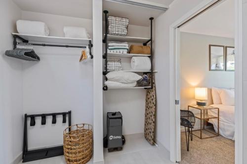 a room with a closet with shelves and a bed at A-303 Haleakala Shores in Wailea