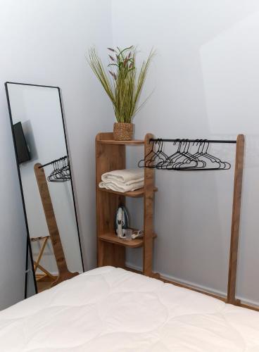 a bedroom with a mirror and a shelf with a bed at Byzantium Suite in the centre of Hermoupolis in Ermoupoli