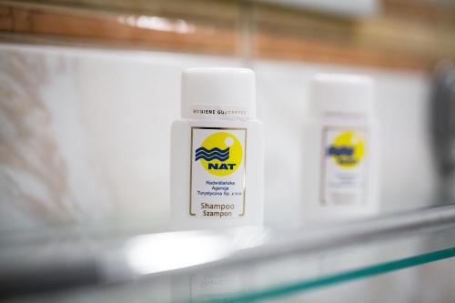 a bottle of nikon bleach on a shelf at OW Carbo Dąbki - w sąsiedztwie lasu i jeziora in Dąbki