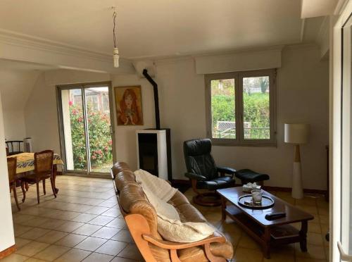 a living room with a couch and a table at Kervig maison à 2 pas des plages in Plestin-les-Grèves