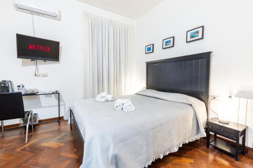 a bedroom with a bed with two towels on it at Corso 151 in Olbia