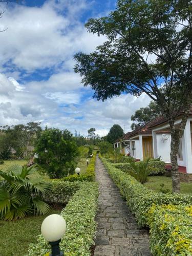 a stone path in front of a house at Andasibe Sifaka Lodge in Andasibe