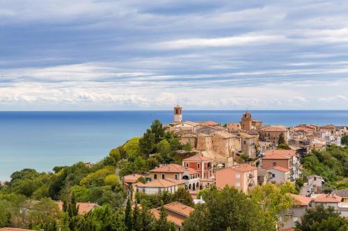 a town on a hill with the ocean in the background at B&B Luci della Collina Boutique Relax in Tortoreto Lido