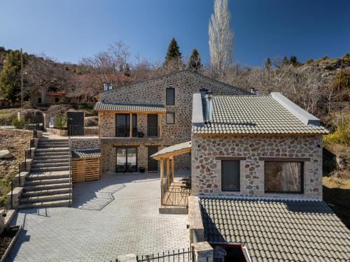 a stone house with a staircase leading up to it at Πηγή Τραγανιστή in Kato Trikala Korinthias