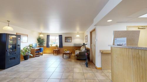 a large room with a living room and a kitchen at Western Executive Inn in Billings
