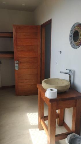 a bathroom with a wooden sink and a wooden door at Quinta las Marias, Ecolodge, camping y Tiny wood house in Guateque
