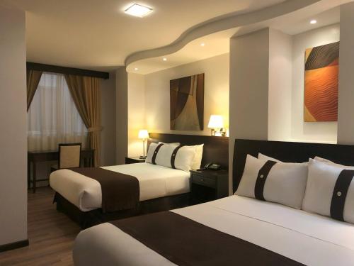 Postel nebo postele na pokoji v ubytování Zamorano Real Hotel