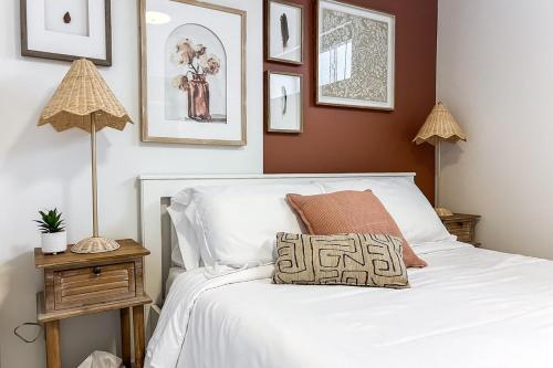 a bedroom with a white bed with a pillow on it at Chic Hideaway-King Bed-Fireplace-DT-WEM-Garage in Edmonton