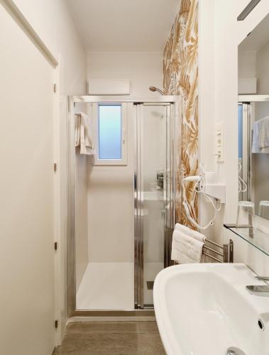 a white bathroom with a shower and a sink at Bilbao ROOMS Etxebarria in Bilbao