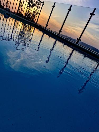 a pool of water with the sunset in the background at עטרת הנוף in Even Menahem