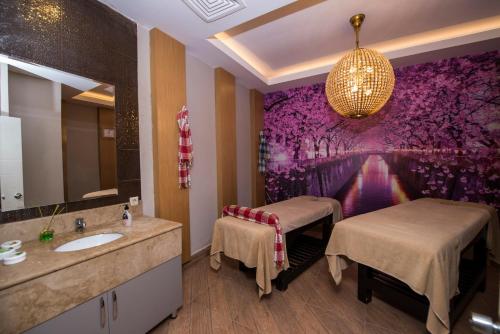 a bathroom with a sink and a mirror at Palm World Side Resort & Spa in Side