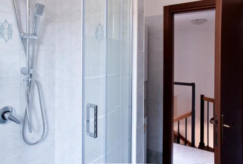 a shower with a glass door in a bathroom at Milano Malpensa AirHome in Somma Lombardo