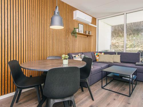 a living room with a table and a purple couch at 2 person holiday home in Ringkøbing in Ringkøbing