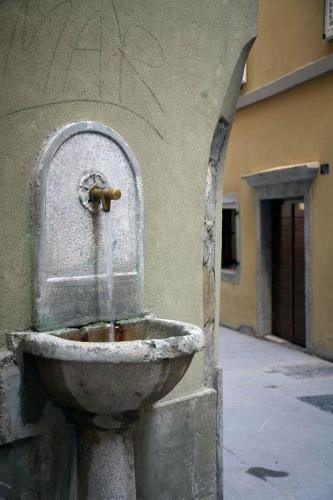 a water fountain on the side of a building at Hotel James Joyce in Trieste