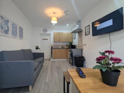 a living room with a couch and a table at Modern Apartment Near Manchester City Centre in Manchester