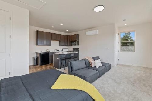 a living room with a couch and a kitchen at Flagstaff Studio Near NAU in Flagstaff