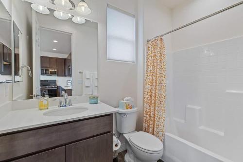 a bathroom with a sink and a toilet and a mirror at Flagstaff Studio Near NAU in Flagstaff