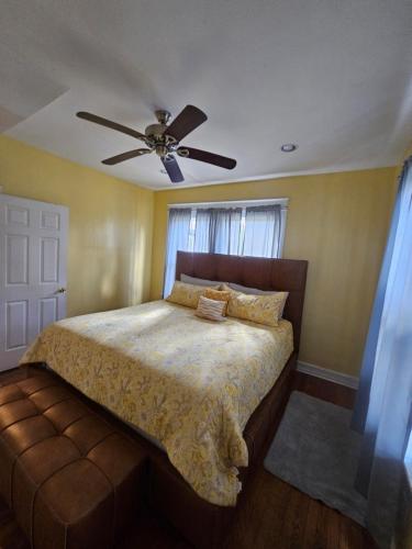 a bedroom with a bed with a ceiling fan at Birmingham's Spacious Uptown Family Retreat in Birmingham