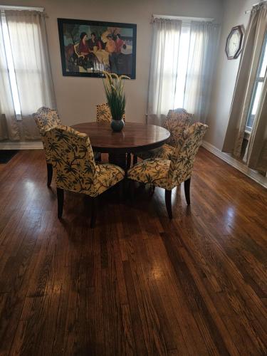 a dining room with a wooden table and chairs at Birmingham's Spacious Uptown Family Retreat in Birmingham