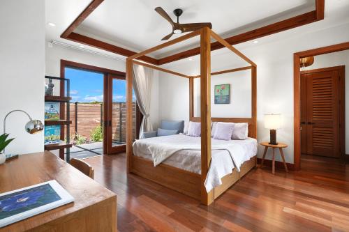 a bedroom with a canopy bed and a desk at Private Luxury 6-bedroom Villa in Kukuiula, Panoramic Ocean View, Heated infinity pool, SPA, Sleep up to 22 in Koloa