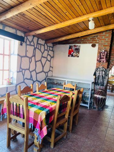 a dining room table with a colorful table and chairs at Cabañas De Lolita En Barrancas del cobre in Areponapuchi