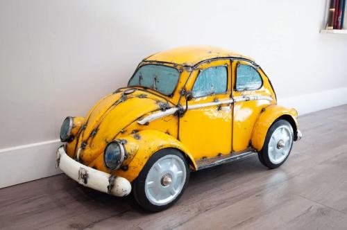 an old yellow car parked in a room at Large Flagstaff Home with Guest House in Flagstaff