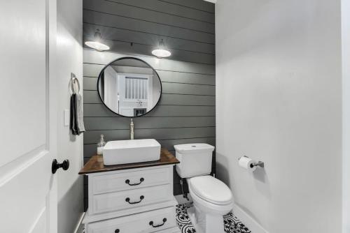 a bathroom with a white toilet and a mirror at Large Flagstaff Home with Guest House in Flagstaff