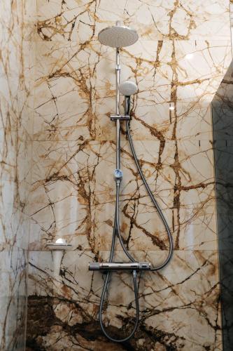 a shower seat in front of a marble wall at Apartments Museum in Sarajevo