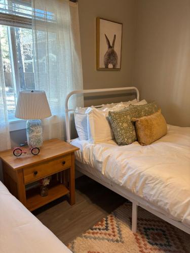 a bedroom with a bed and a table with a lamp at Large Flagstaff Home with Guest House in Flagstaff