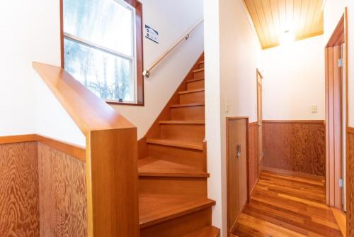 a staircase in a house with a window at Green Oasis Cottage A in Hakone