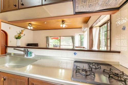 a kitchen with a sink and a stove at Green Oasis Cottage B in Hakone